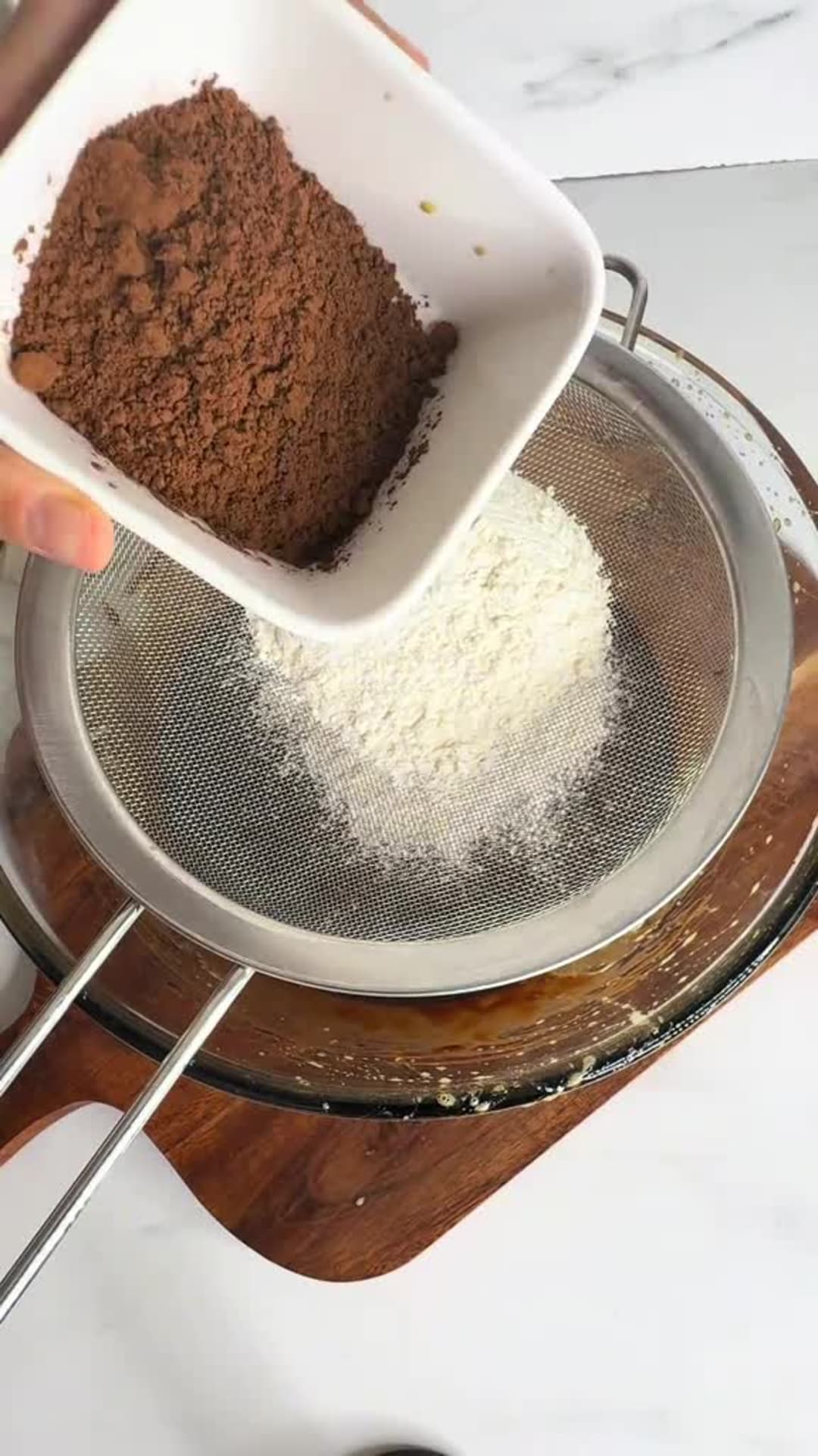 Fudgy Chocolate Strawberry Nutella Brownies - Sifting flour and cocoa powder