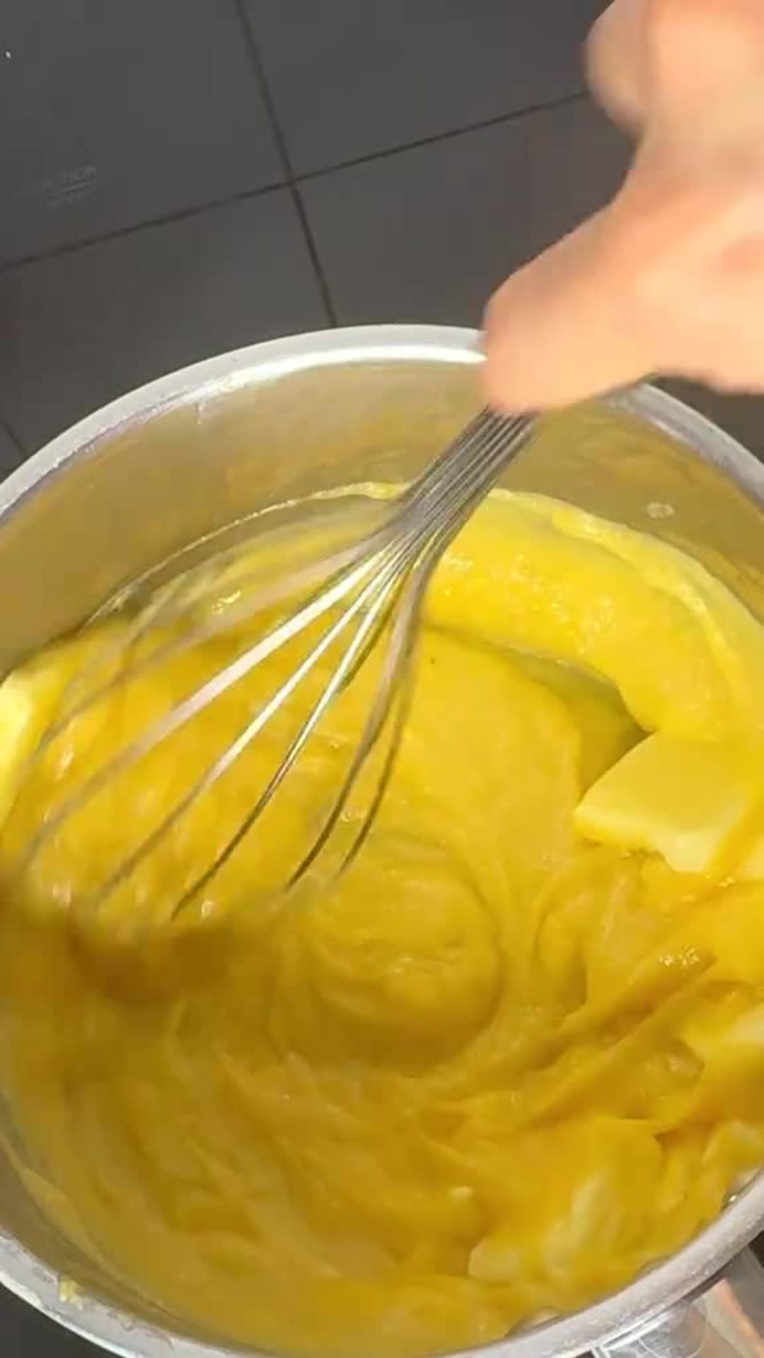 No-Bake Lemon Cheesecake Bars - Whisking butter into warm lemon curd