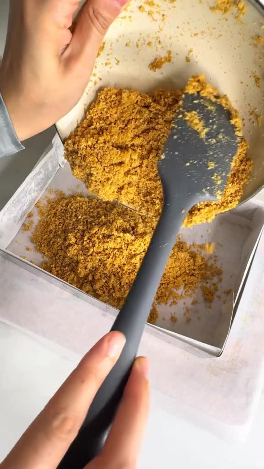 No-Bake Lemon Cheesecake Bars - Pressing biscuit layer into pan