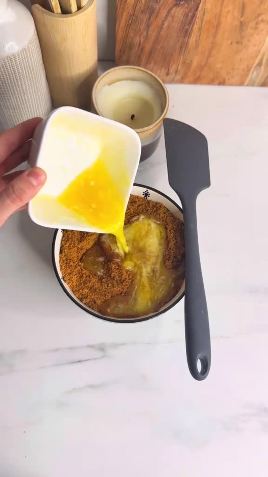 No-Bake Speculoos Tiramisu Cheesecake - Mixing butter with cookie crumbs